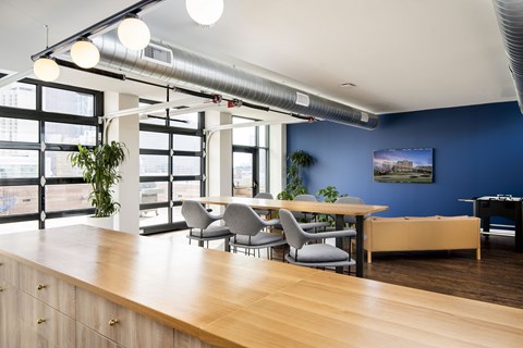 A conference room with a long table and chairs.